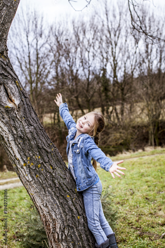 young beautiful girl is climbing on tree young beautiful girl is climbing on tree