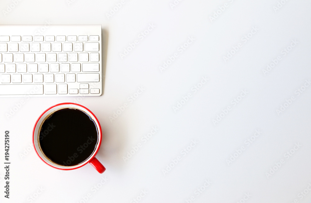 Top view Red Coffee Cup and keyboard on office desk.Top view with copy space. Top view Red Coffee Cup and keyboard on office desk.Top view with copy space.