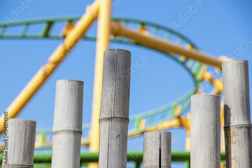 light browgreen yellow rollercoaster open cloudy blue skyn bamboo and green yellow railway blue sky photo