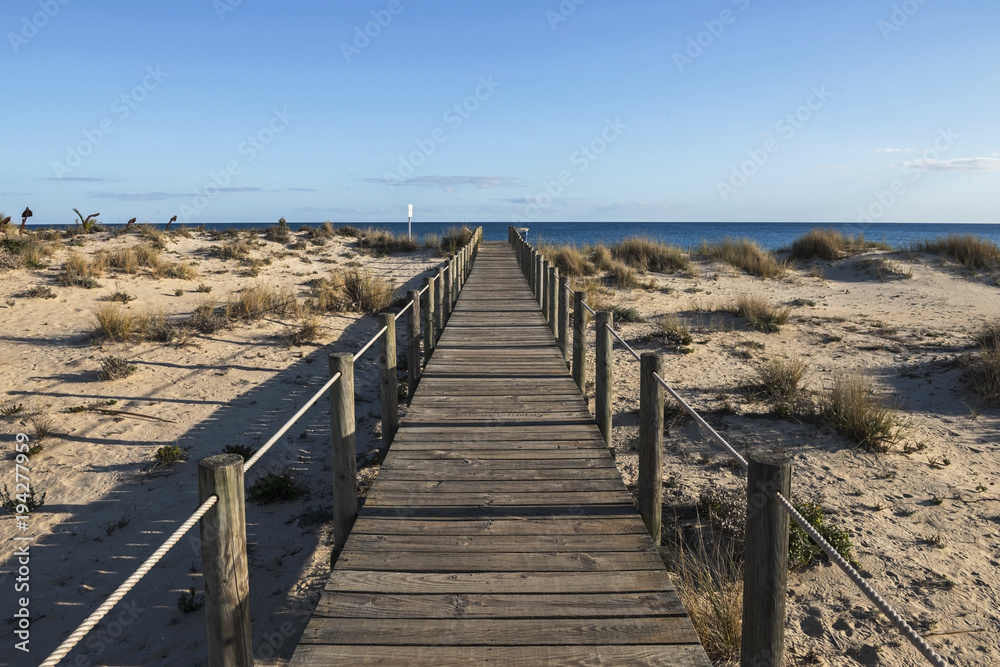 Wooden bridge leading through the dunes to the Atlantic Ocean, Portugal