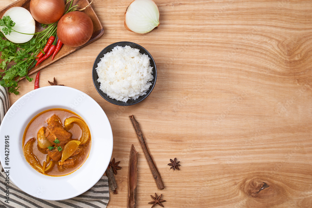 spicy chicken and rice on wooden background
