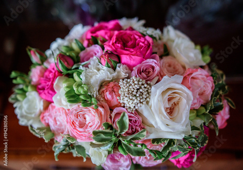 Rich wedding bouquet made of pink and white roses