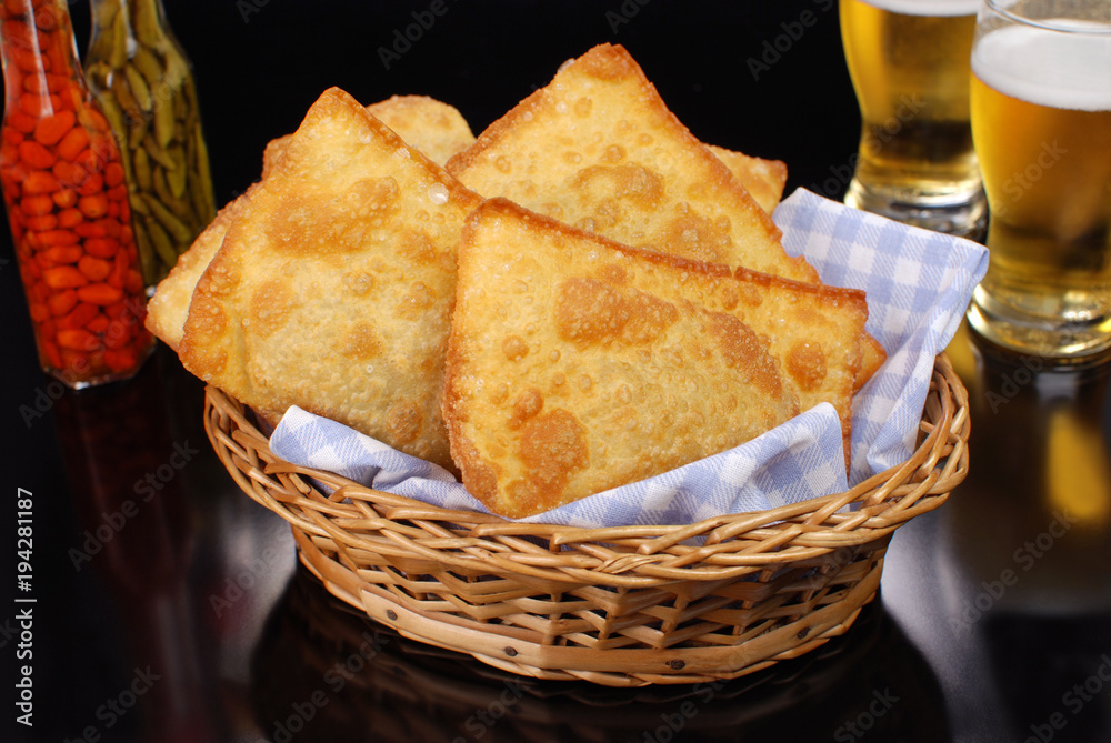 Brazilian typical pastry called pastel in black pub table background  - obrazy, fototapety, plakaty 