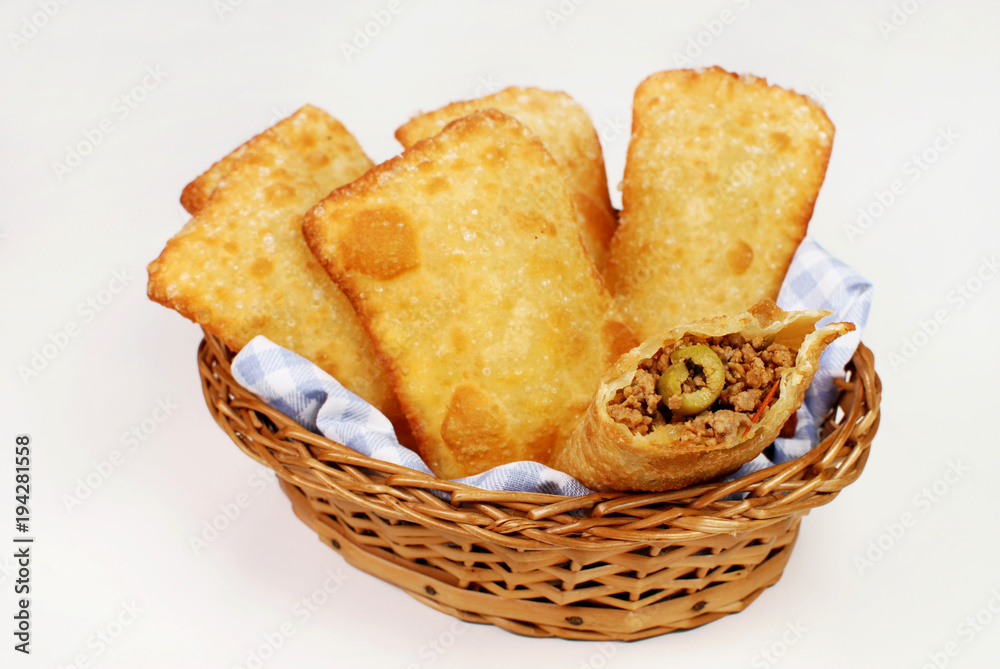Brazilian typical pastry called pastel in white background with one of meat open - obrazy, fototapety, plakaty 