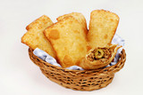 Brazilian typical pastry called pastel in white background with one of meat open