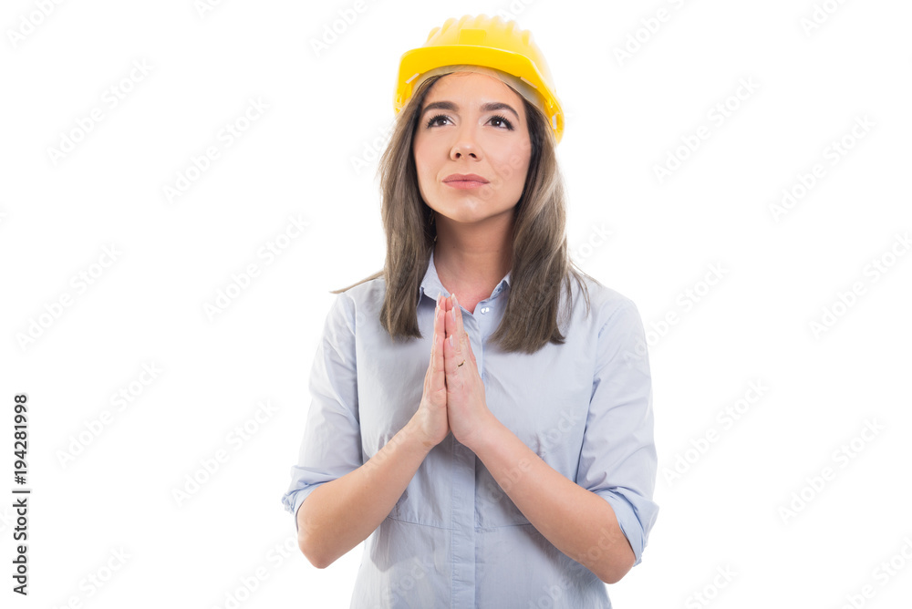 Portrait of female constructor making praying gesture. Portrait of female constructor making praying gesture.