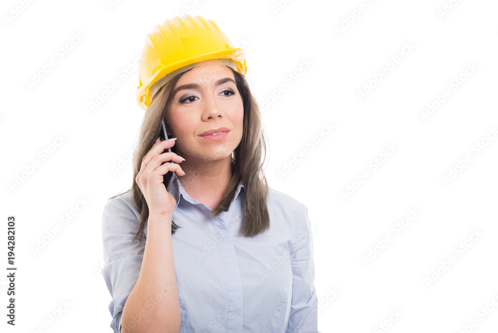 Portrait of female constructor talking at telephone. Portrait of female constructor talking at telephone.