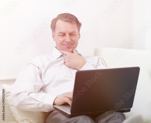 businessman with laptop works in the room