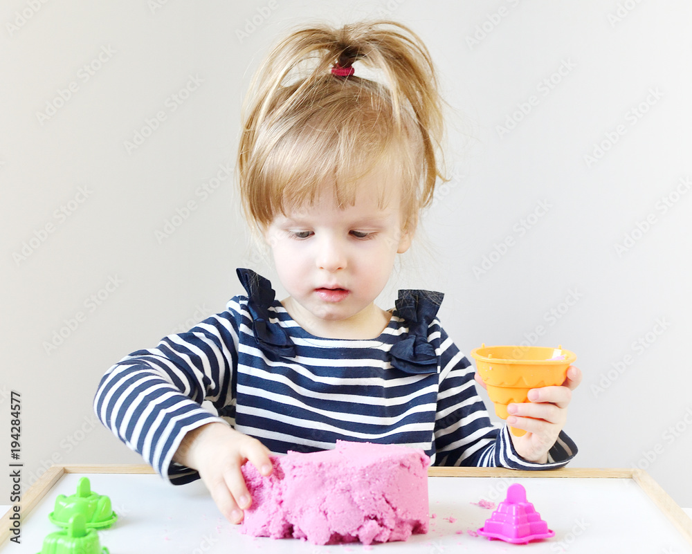Little Caucasian Girl Playing with Pink Kinetic Sand at Home, Early Education, Preparing for School, Development Little Caucasian Girl Playing with Pink Kinetic Sand at Home, Early Education, Preparing for School, Development