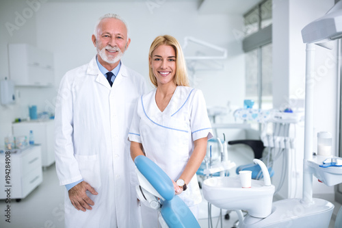 Two smiling dentists in a dental office