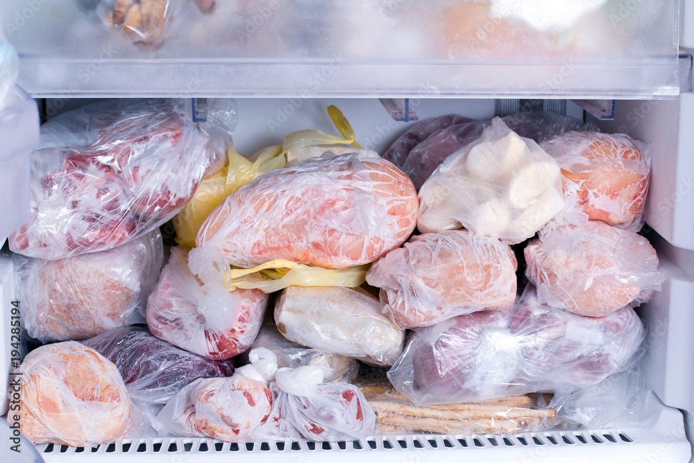 Foto Stock Refrigerator with frozen food. Open fridge freezer (meat, milk,  vegetables). | Adobe Stock