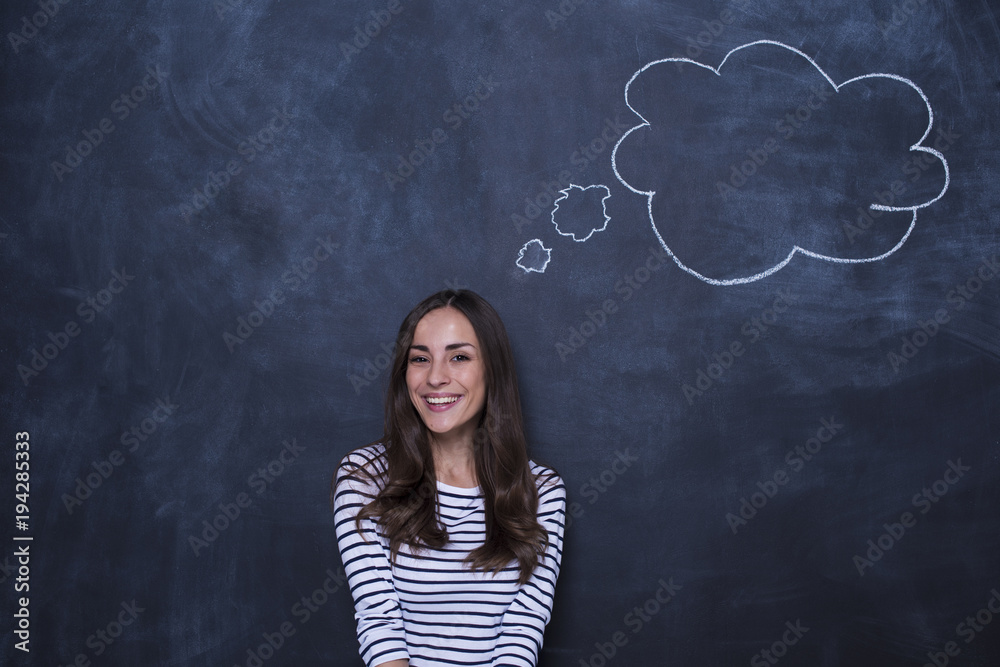 Concept of human thoughts. Thoughts of an attractive smiling young woman in casual clothes