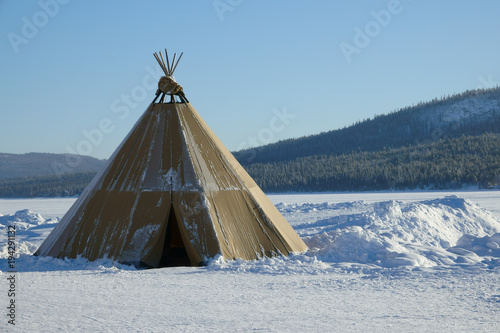 Winter polar landscape with eskimo tent.