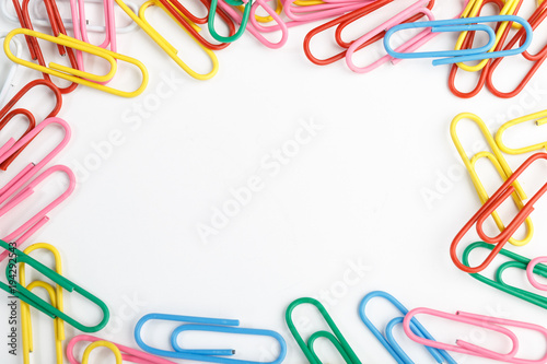 A lot of colorful paper clips on white background.