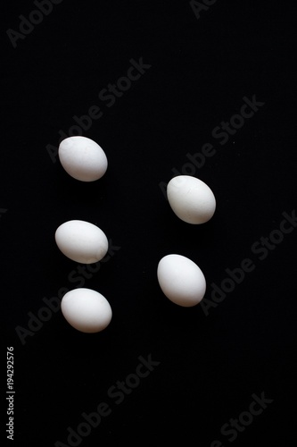 White eggs on black background 