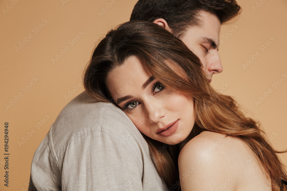 Carefree calm woman looking camera while lying on her man shoulder Carefree calm woman looking camera while lying on her man shoulder