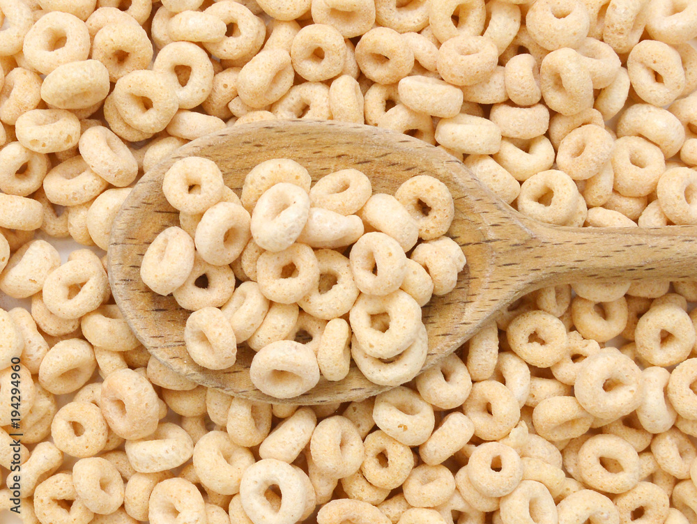 healthy cereal rings and wooden spoon on background healthy cereal rings and wooden spoon on background