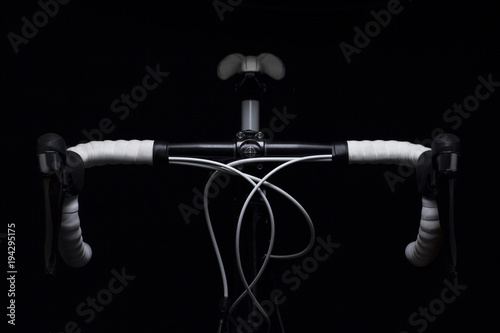 detail of a racing bike in soft light / elegant detail of the handlebars of a racing bike