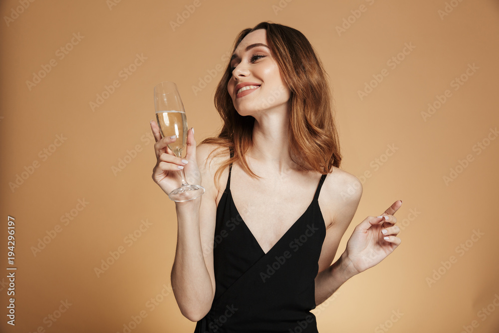 Young happy woman looking away and smiling with champagne Young happy woman looking away and smiling with champagne