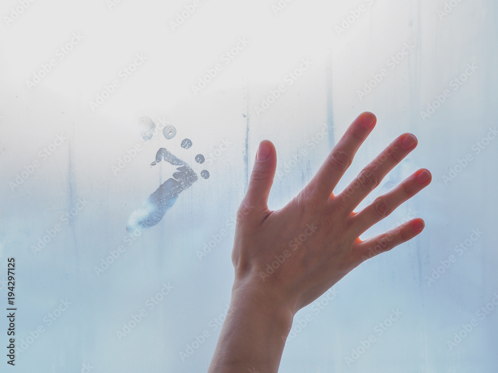 © sablinstanislav - Beautiful female hand on misty glass. © sablinstanislav - Beautiful female hand on misty glass.