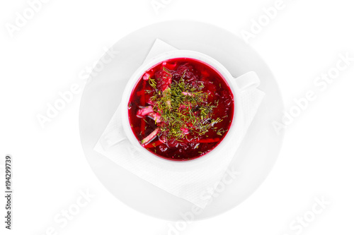Borsch, beetroot, beetroot soup with seasoning, decorated with dill. On a napkin in a white plate isolated white. Serving dishes in a cafe, restaurant, for a menu. View from above