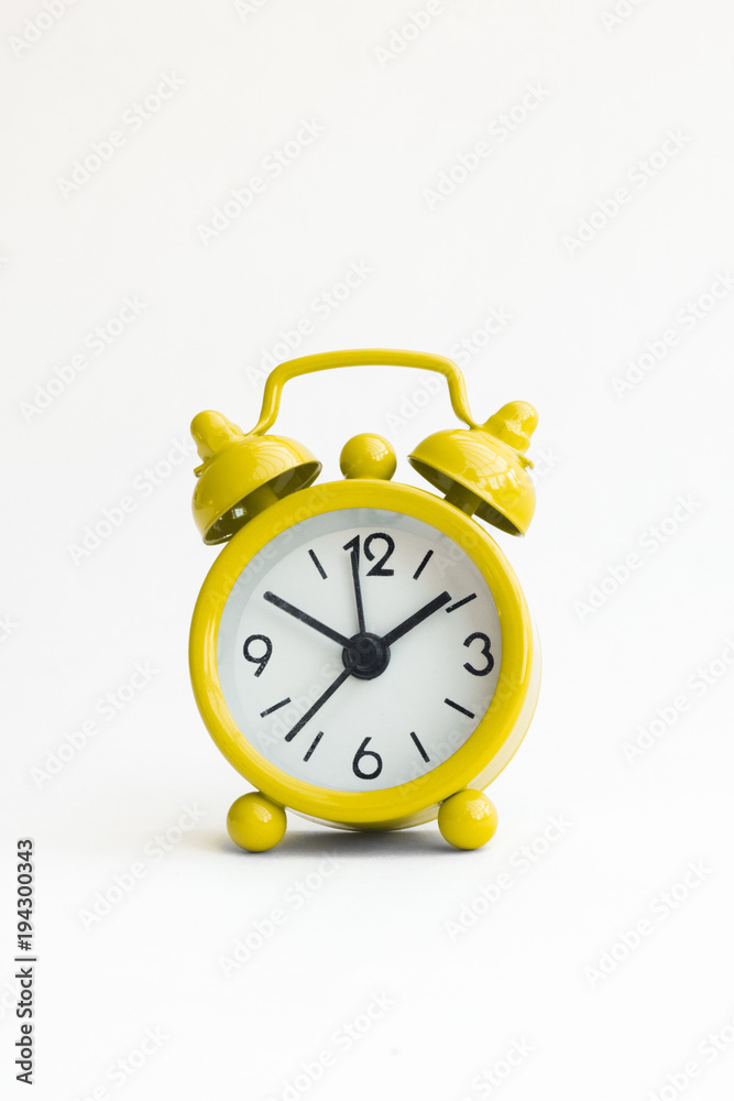 small analogue yellow golden clock in isolated white background small analogue yellow golden clock in isolated white background