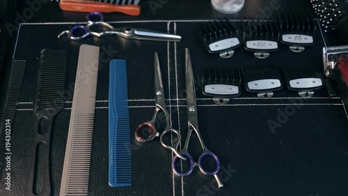 Close-up panorama shot of hairdresser tools. Scissors and combs.