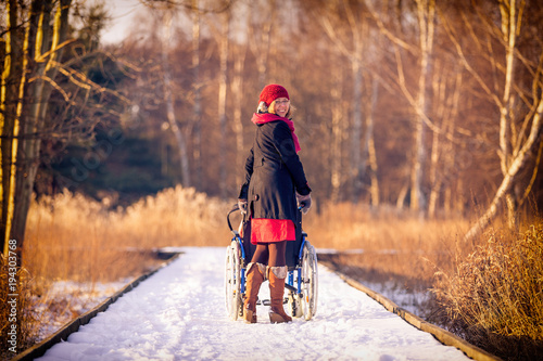 young woman running the wheelchair in the park