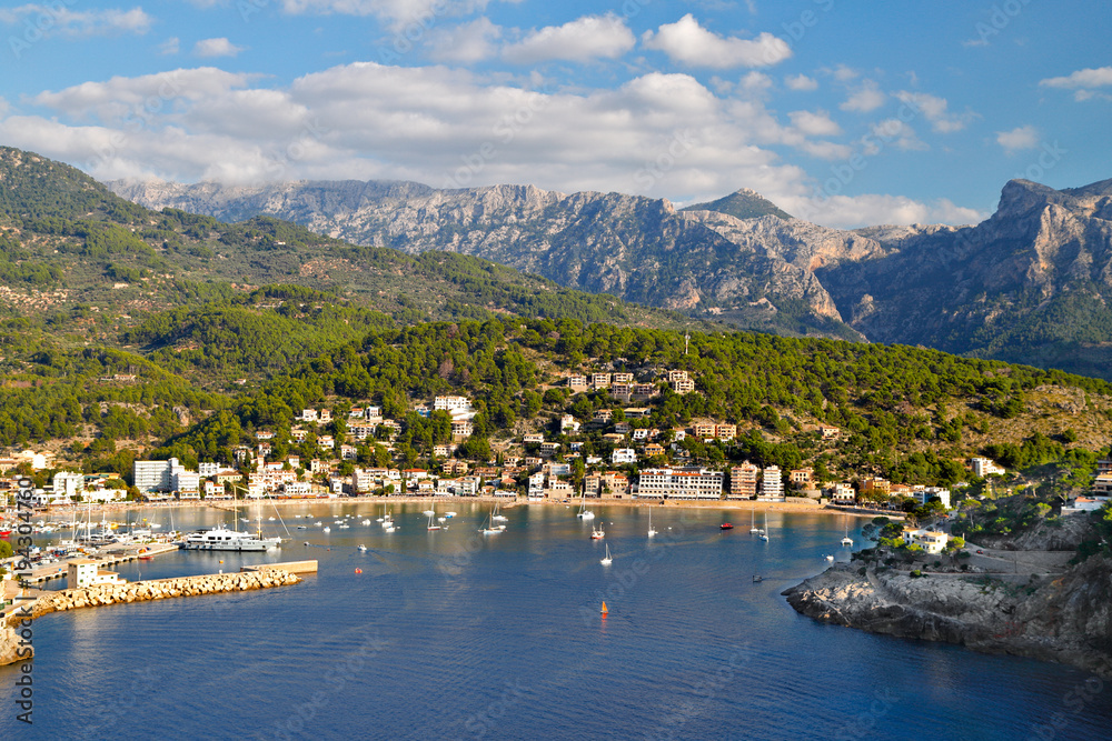 Port de Soller seaside resort in a bay on the coast of Mallorca with Serra de Tramuntana mountains in the background