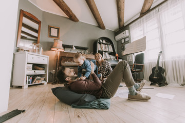 Happy young family playing on the floor