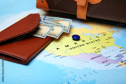 Wallet with money on map. A...