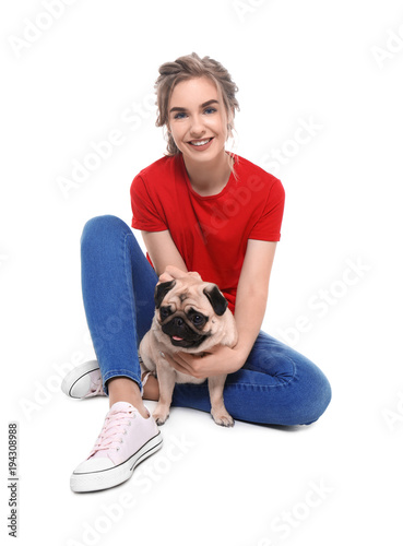 Young woman with cute pug d...