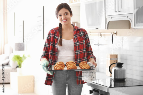 Woman holding tray with cro...
