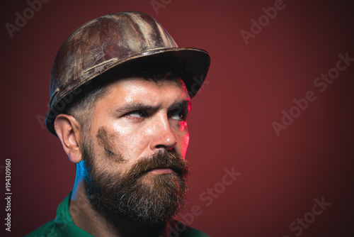 Architect, worker, engineer - work. Builder working with construction helmet. Portrait bearded man with protect helmet wearing. Man builder. Copy space for advertising.