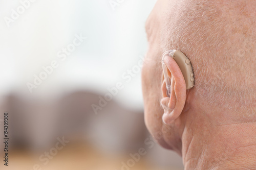 Senior man with hearing aid...