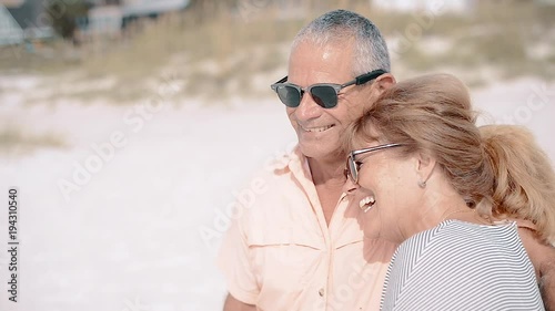 Laughing Middle-Aged Man and Woman at the Beach