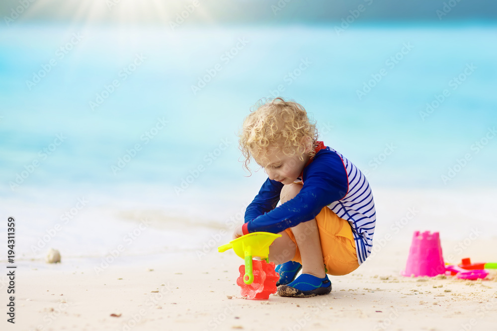 Kids play on tropical beach. Sand and water toy. Kids play on tropical beach. Sand and water toy.