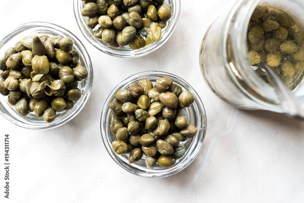 Jar of Capers in Glass Bowl. Jar of Capers in Glass Bowl.