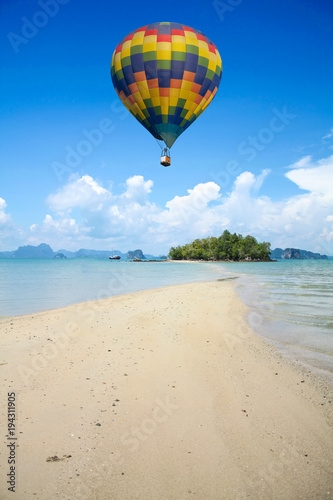 Colorful hot air balloon fly over the sea.