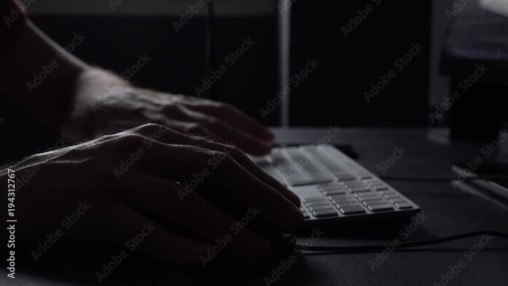 Hand using compute mouse, low key