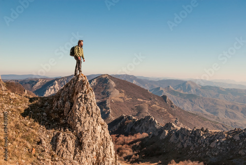 A happy traveler on a mountain top photo