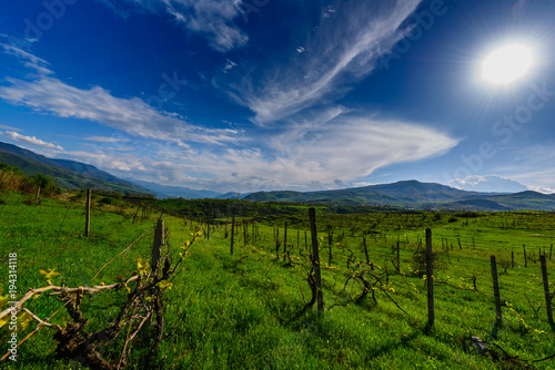 Amazing spring skyscape with beautiful clouds and green field  Armenia