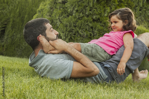 Baby girl playing with daddy outside. Family lifestyle. Summer time © Susana Valera