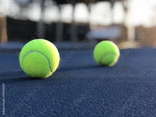 Tennis Balls By Net On Blue Tennis Court Low Angle © DJack Studio