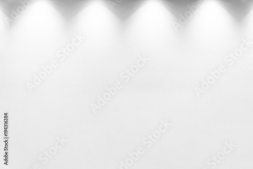 Empty white wall with halogen with lamps.