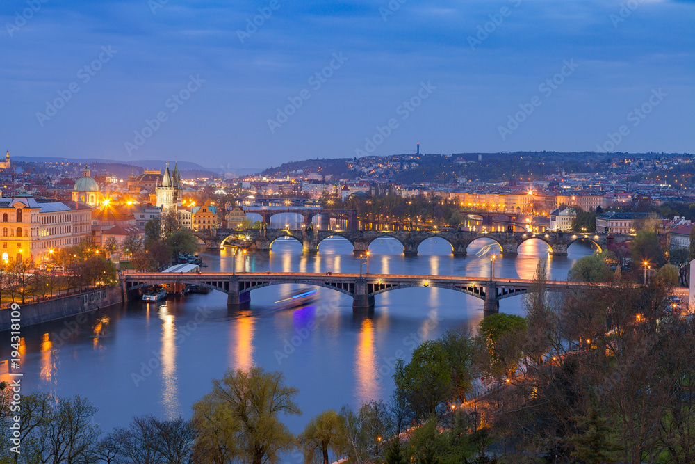 Old town and bridges over Vltava river illuminated night view from Letenske garden. Prague, Czech Republic