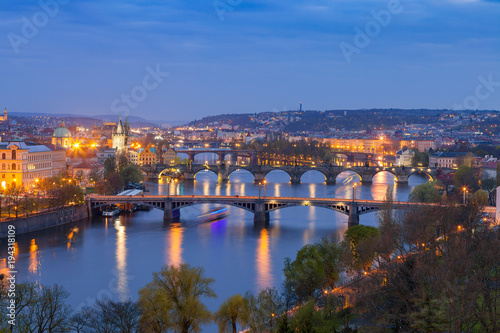Old town and bridges over Vltava river illuminated night view from Letenske garden. Prague, Czech Republic