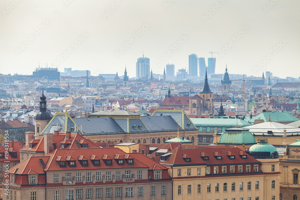 Prague rooftops. Beautiful aerial view of historic center area architecture with red roofs and modern buildings on the background