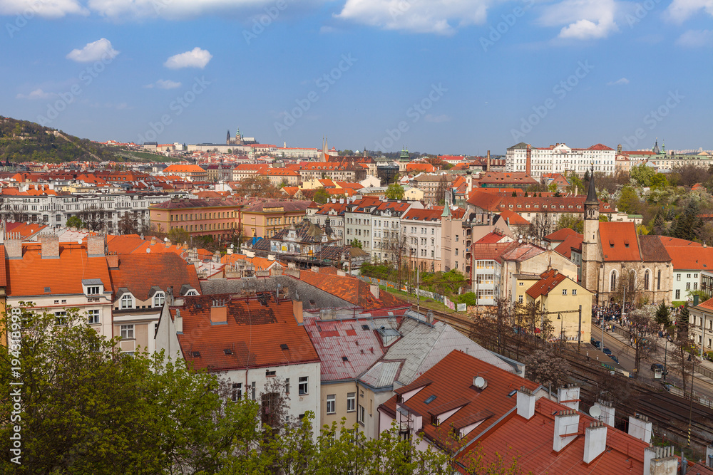Prague skyline with castle and living blocks red rooftops with park and trees Prague skyline with castle and living blocks red rooftops with park and trees
