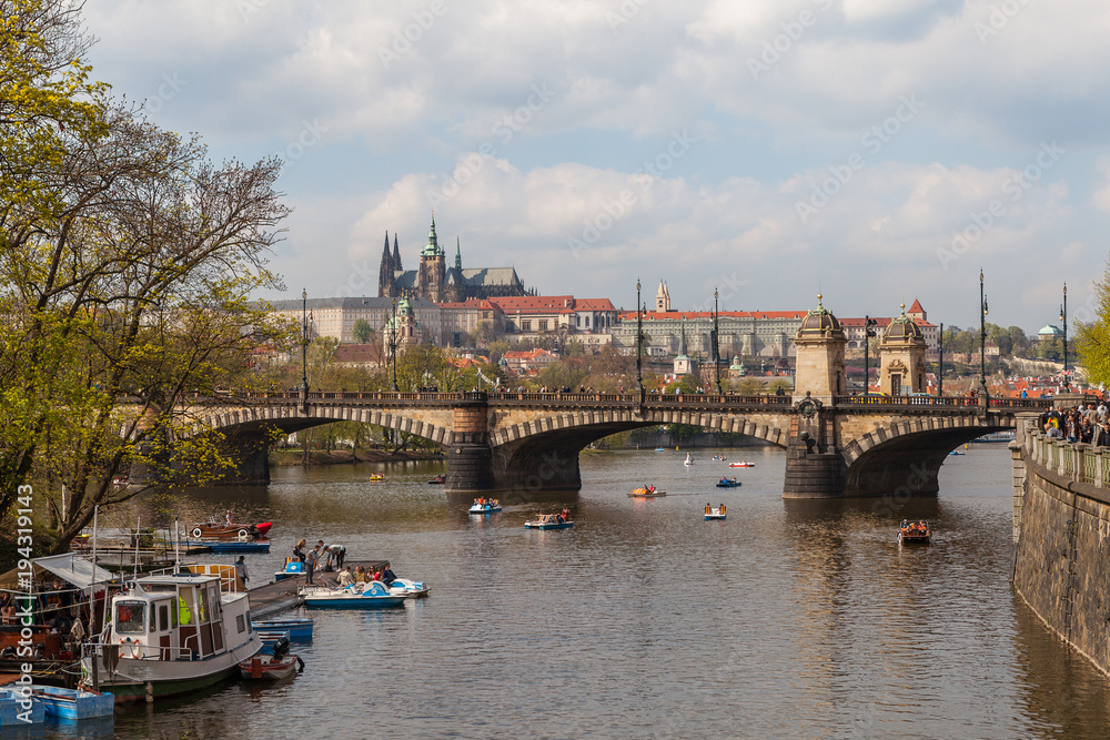 PRAGUE, CZECH REPUBLIC - APRIL 12, 2017: View on the river Vltava, bridge and boats. Old town, summer season.